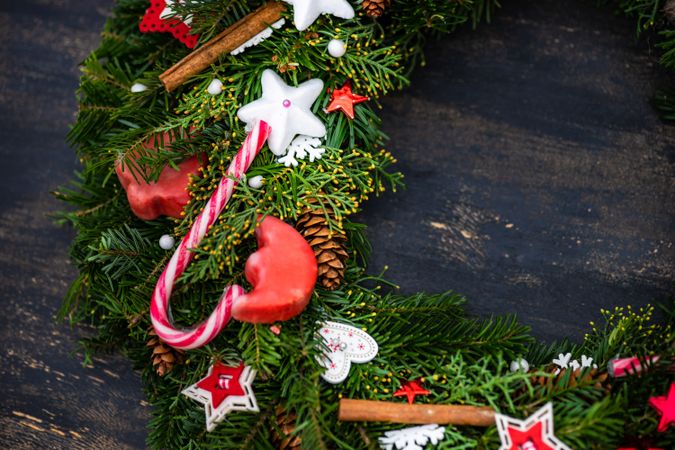 Top view of Christmas wreath with candy cane, cinnamon and stars