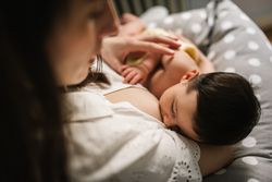 Mother feeding baby at home