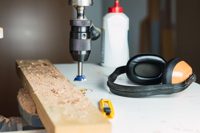 Modern drilling machine in grunge carpentry
