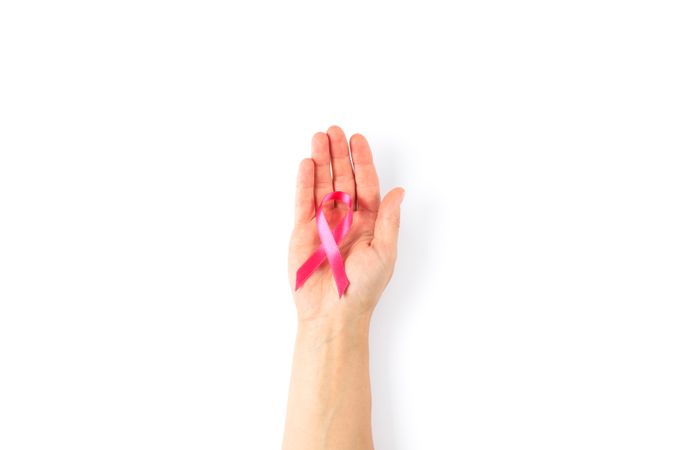 Female hand with pink awareness ribbon isolated on blank background