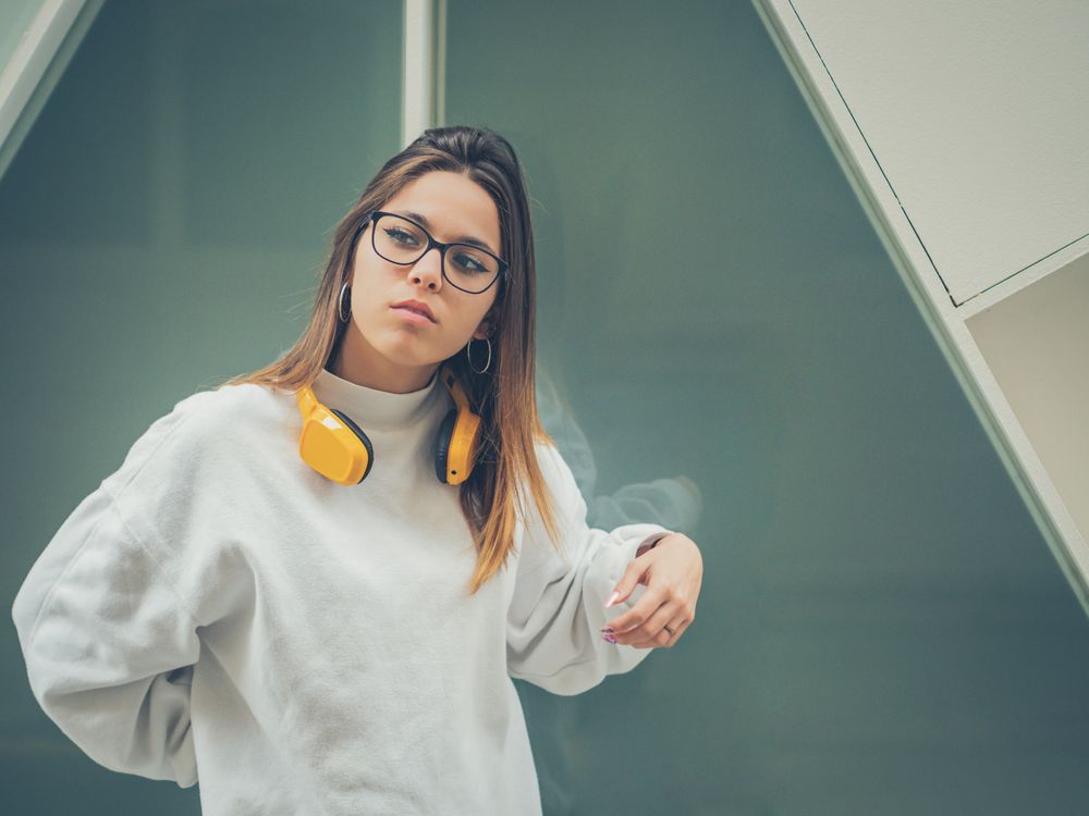 Trendy young woman with headphones and smartphone