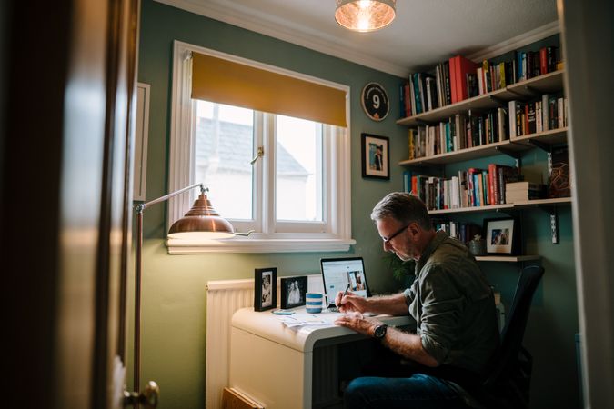 Older man working in small home office