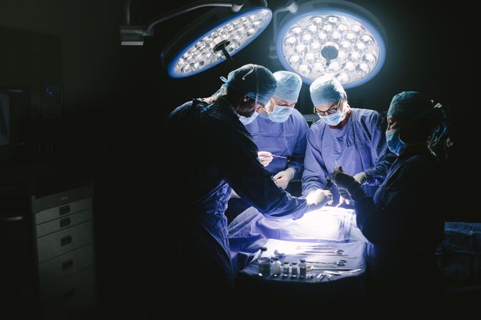 Doctors during surgery on patient in hospital