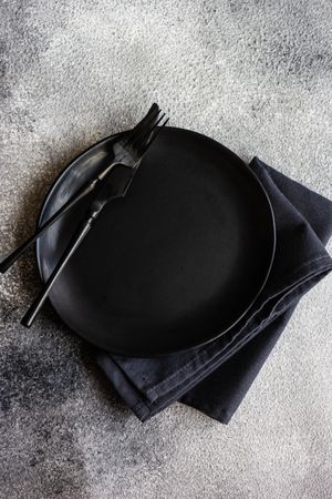 Top view of table setting with elegant dark plate