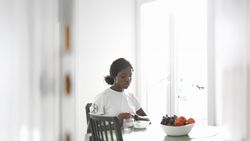 Casual Morning Scene: Woman Eating Cereal at Home.