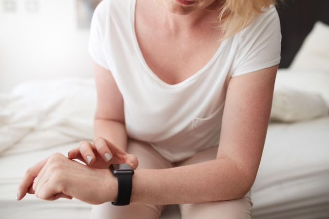Closeup shot of white female checking time on her wrist watch