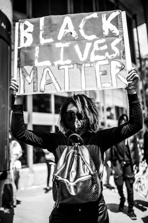 MONTREAL, QUEBEC, CANADA – June 7 2020- Woman holding “Black Lives Matter” sign