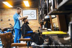 Barber cutting a bearded man’s hair 41Dz75
