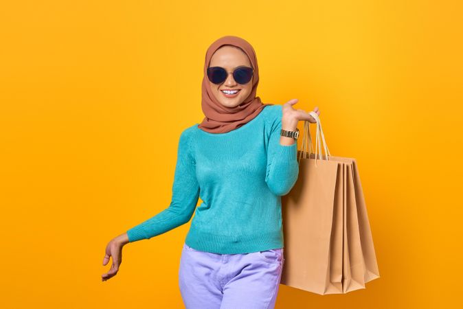 Fabulous Muslim woman holding shopping bags