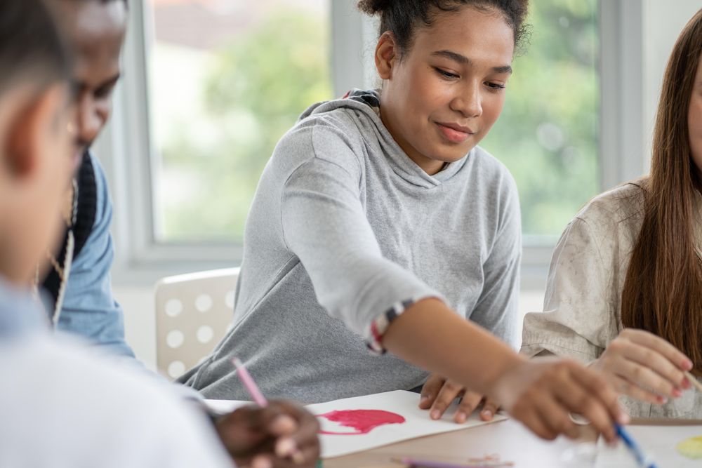 Black teenage student in painting class