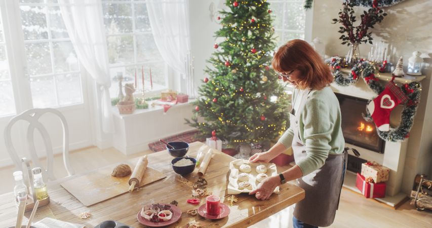 Portrait of Older Female Making Cinnamon Buns for Christmas at Home.