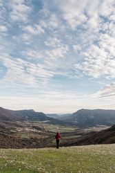 Anonymous woman admiring view of valley and mountains