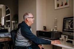 Man editing photos in his home office
