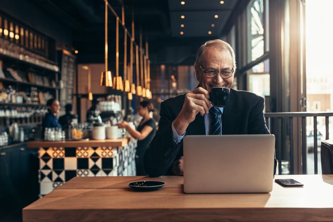 Happy professional male enjoying coffee in the morning