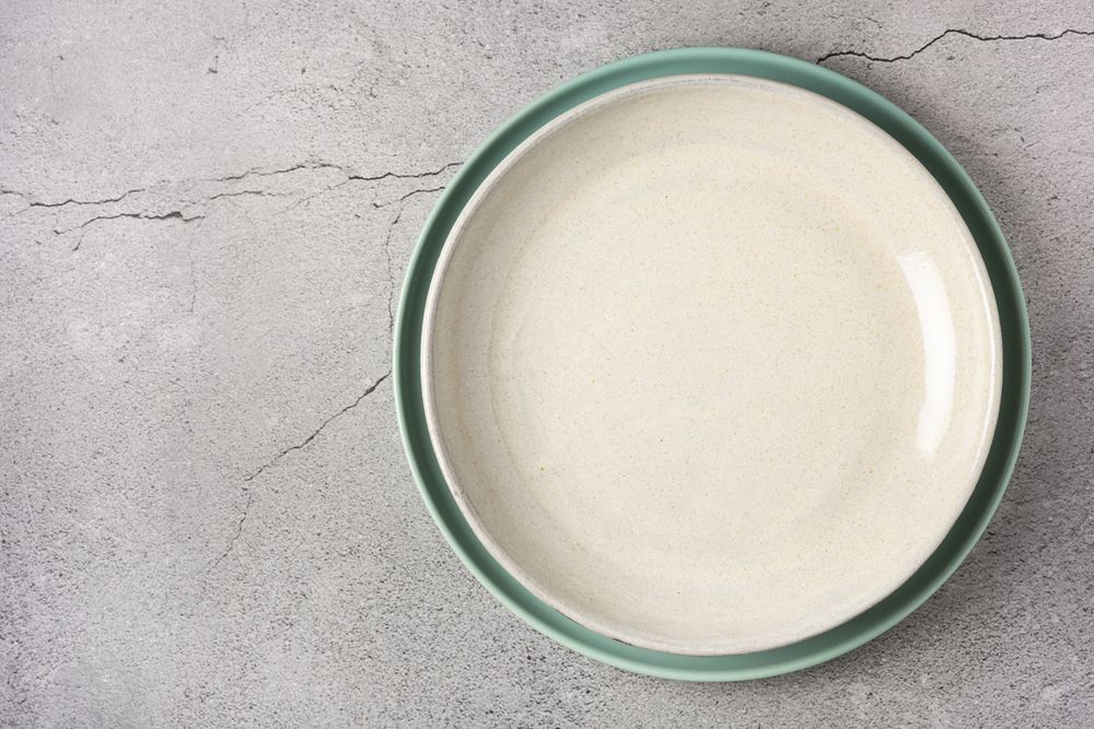 Empty plate on the slate table. Top view of the image.