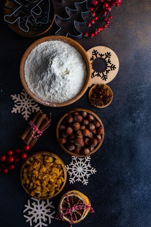 Top view of Christmas baking ingredient on dark kitchen counter