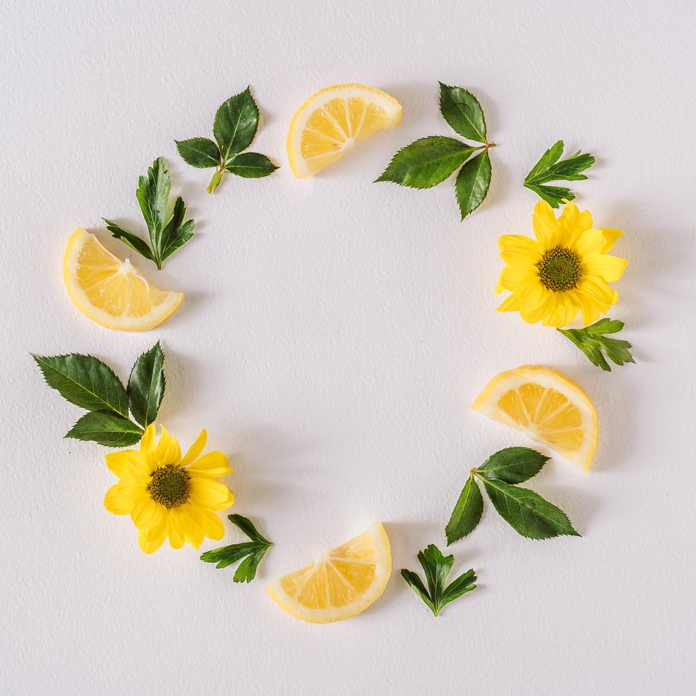 Round wreath of yellow flowers lemon slices and leave