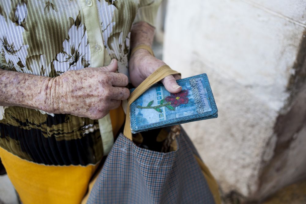 Woman holding blue book and bag