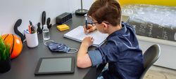 Teenager doing homework in his room