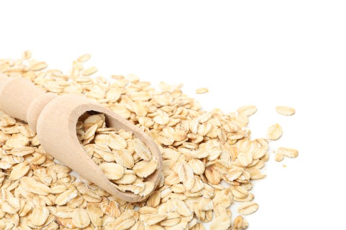 Scoop with oatmeal flakes isolated on plain background