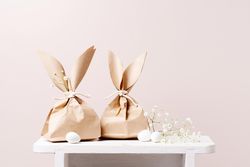 Two paper bags in Easter bunny shapes on table