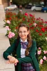 Girl in school uniform smiling confidently
