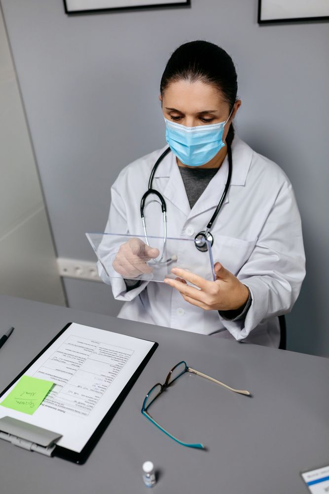 Female doctor working with transparent tablet in office
