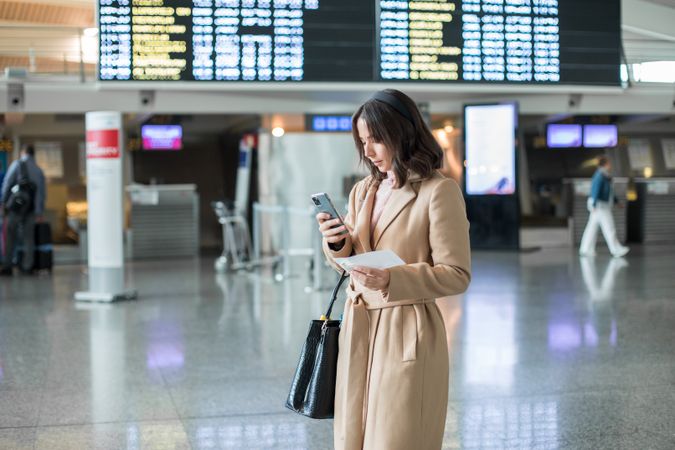 Woman using smartphone at airport