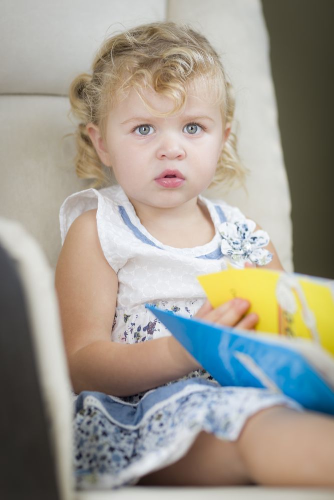 Sweet Little Girl Reading Her Book