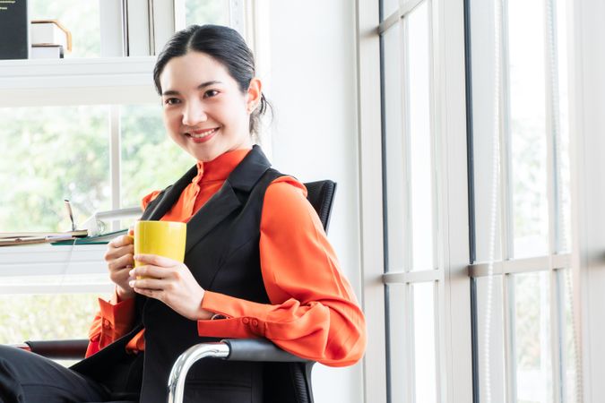 Happy and calm woman in a bright office
