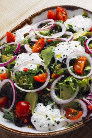 Vegetables salad with onion greens and cream sauce