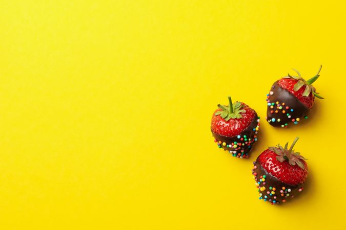 Chocolate fondue. Strawberry in chocolate on yellow background