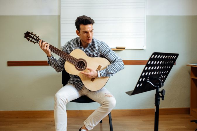 Man playing guitar in studio