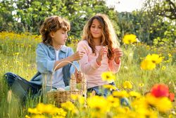 Boy giving flower to girl on Easter day