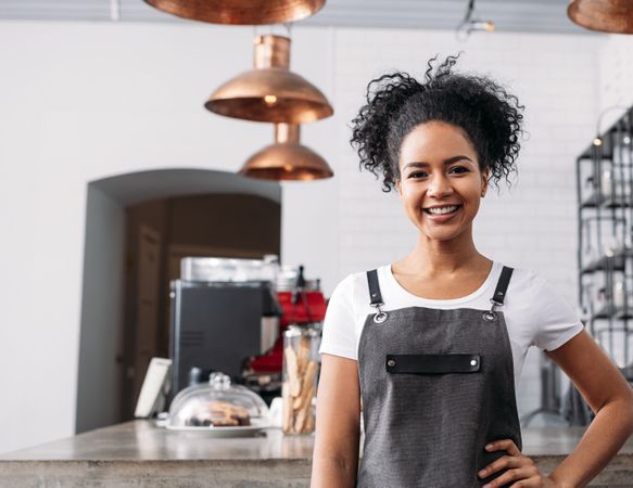 Small business owner standing in her cafe 