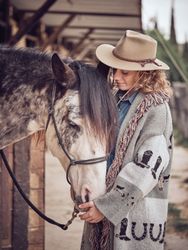 Woman near horse in paddock
