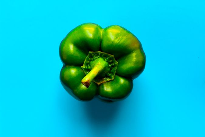 Top view of green pepper on blue background