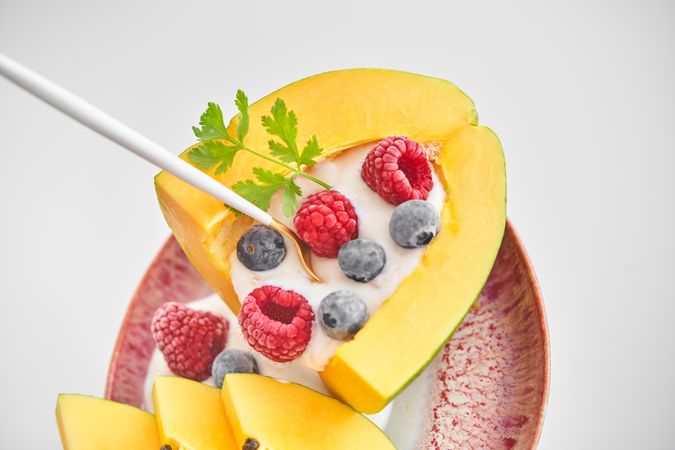 Appetizing dessert made of papaya and berries