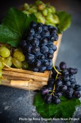 Close up of box of fresh green & red grapes on grey kitchen counter 5XrE7P