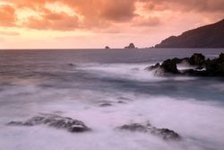 Amazing stone shore and pink sky with clouds