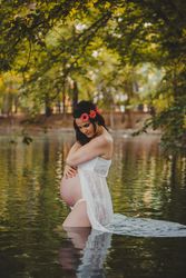 Pregnant woman standing in lake water