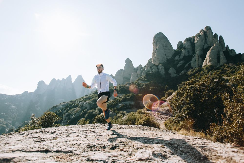 Male running on rugged terrain in the sunshine