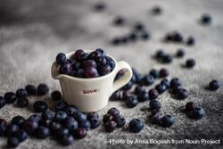 Blueberries around "love" ceramic pouring cup beX8VN