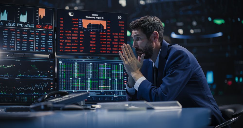 Financial Crisis Concept with Stock Broker Saddened by Negative Ticker Information, Red Graphs and Real-Time Data