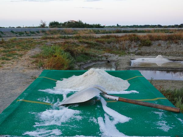 Salt mound and shovel on tarp