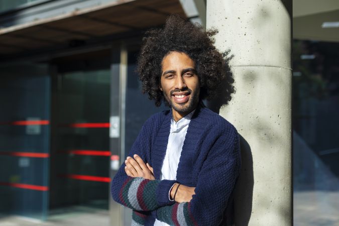 Portrait of Black man standing with arms crossed on sunny day