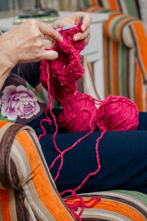 Hands of woman knitting a wool sweater