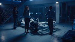 Automobile Engineers Working on Electric Car Platform Chassis, Using Tablet Computers with CAD Software for 3D Concept
