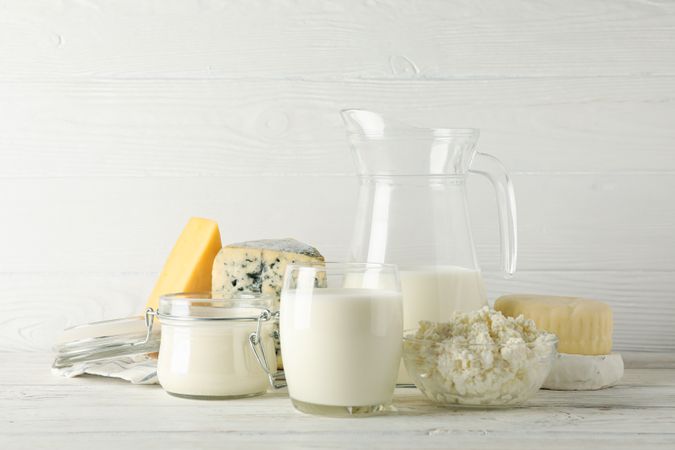 Different dairy products on wooden background, copy space