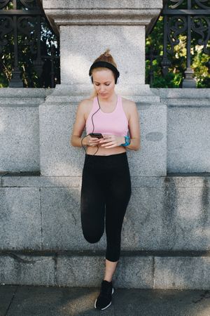 Woman with sportswear listening to music with headphones